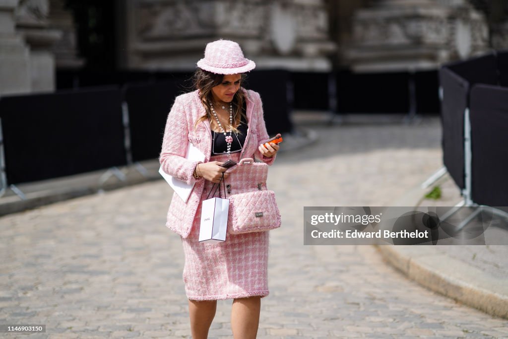A guest wears a Chanel pink tweed jacket, a pink tweed skirt, a News  Photo - Getty Images