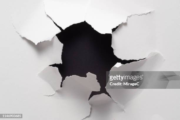 broken paper hole - exploded object stock pictures, royalty-free photos & images