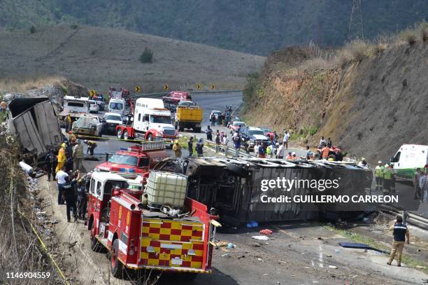 Rescue personal work at the site of a road accident in Coatzacoalcos, state of Veracruz, Mexico on May 29, 2019. - A semi truck and a bus carrying...