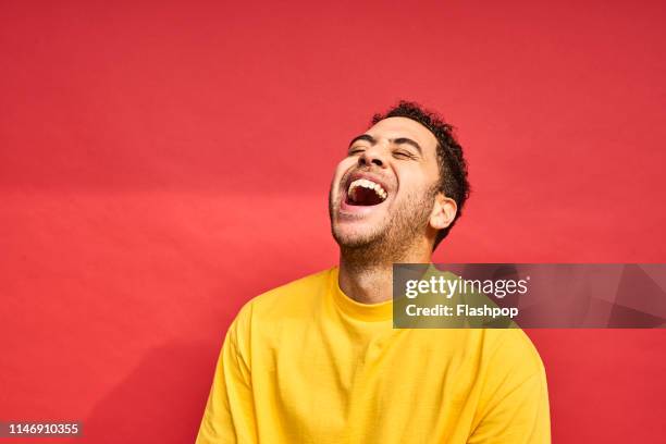 colourful studio portrait of a young man - gay person color background stock pictures, royalty-free photos & images