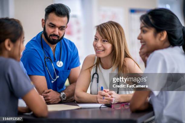 doctor's meeting - civilian stock pictures, royalty-free photos & images