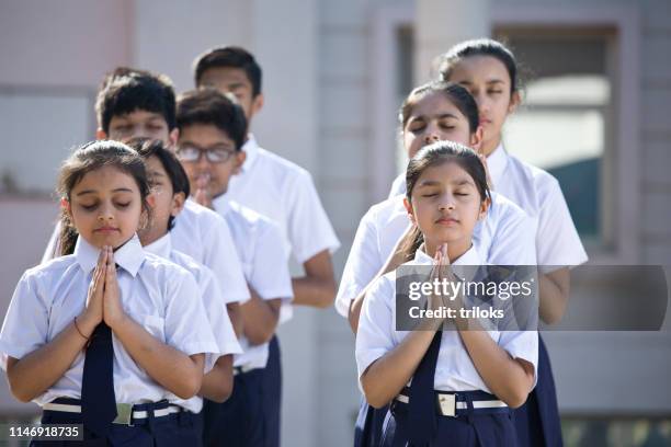 students praying in school campus - school auditorium stock pictures, royalty-free photos & images