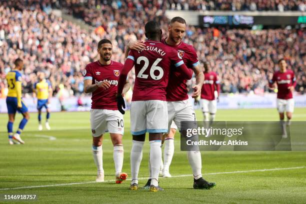 Marko Arnautovic of West Ham United celebrates with teammates after scoring his team's second goal during the Premier League match between West Ham...