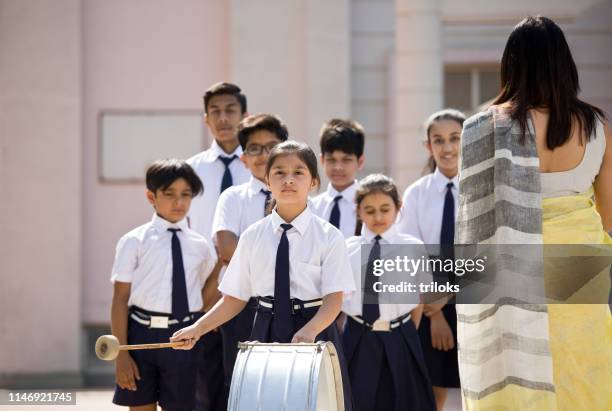 teacher with marching band in school assembly - assembly room stock pictures, royalty-free photos & images