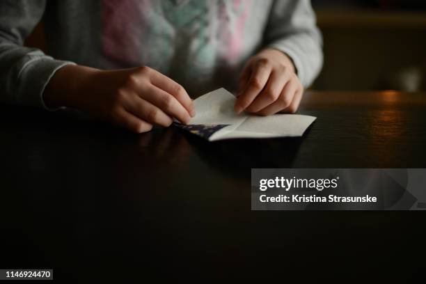 a girl folding origami paper - origami stock pictures, royalty-free photos & images