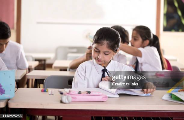 group of students studying book at classroom - classroom india stock pictures, royalty-free photos & images