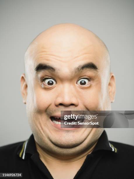 portrait of real chinese adult man with surprised expression looking at camera - human head bald stock pictures, royalty-free photos & images