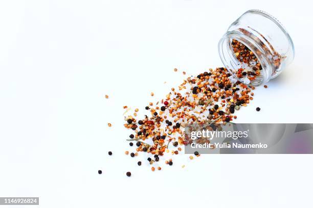 peppercorns spilled on a white background - ペッパー ストックフォトと画像