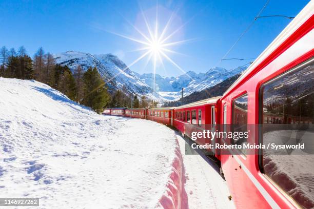 bernina express train, morteratsch, switzerland - winter wonder land stockfoto's en -beelden