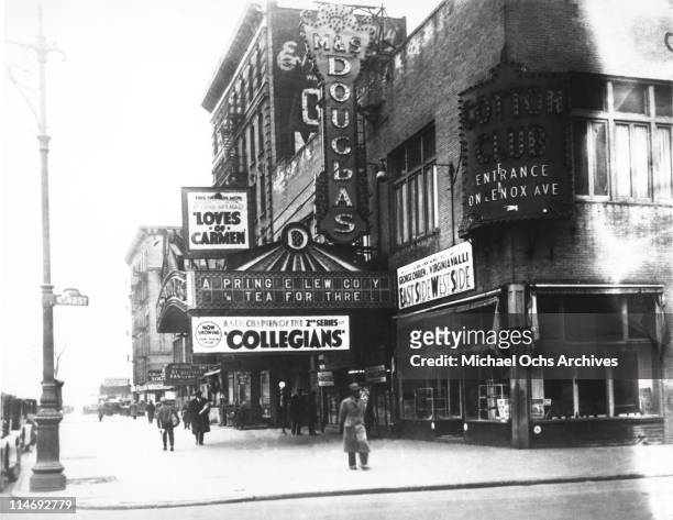 View of the corner of Lennox Avenue and 147th Street in Harlem showing the exterior of the M&S Douglas Theatre and a sign for the Cotton Club a few...