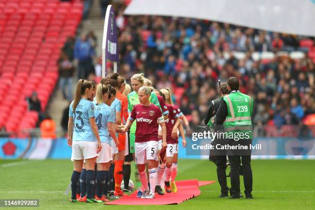 Gilly Flaherty of West Ham United Ladies leads her team as they shake hands with the Manchester City Women's team prior to the Women's FA Cup Final...