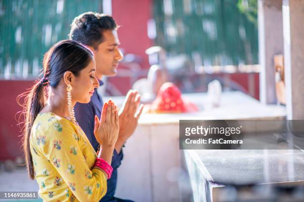 indian family praying together - respect stock pictures, royalty-free photos & images
