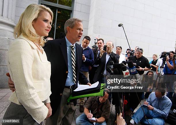 Elizabeth Smart listens to her father Ed Smart talk to the press outside of federal court after the sentencing of Elizabeths kidnapper Brian David...
