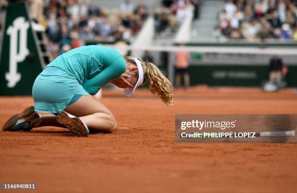 Russia's Ekaterina Alexandrova celebrates after winning against Australia's Samantha Stosur during their women's singles second round match on day...