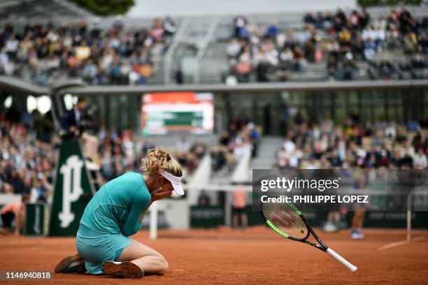 Russia's Ekaterina Alexandrova celebrates after winning against Australia's Samantha Stosur during their women's singles second round match on day...