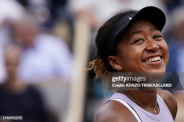 Japan's Naomi Osaka celebrates after winning against Belarus' Victoria Azarenka during their women's singles second round match on day five of The...