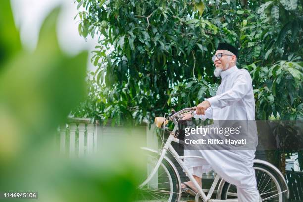 Grandfather with Bicycle Celebrating Hari Raya Aidilfitri (Eid al-Fitr)