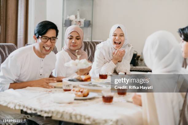 family eating together during hari raya aidilfitri - ramadan family stock pictures, royalty-free photos & images