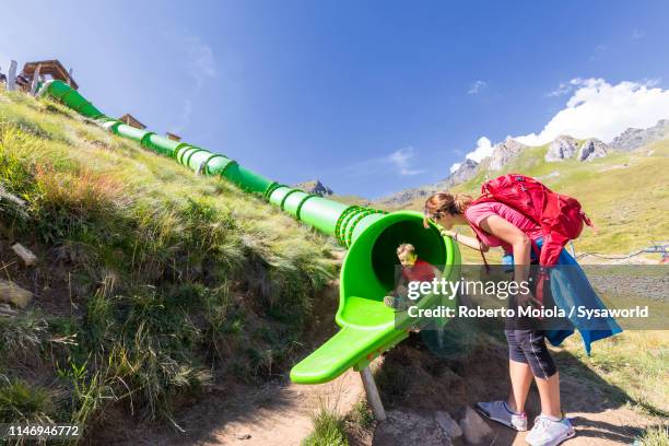 mother and son at playground, passo del tonale, italy - 2 slides stock pictures, royalty-free photos & images