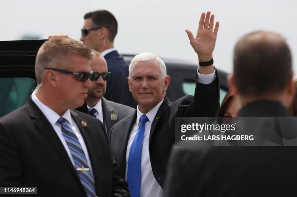 Vice President Mike Pence waves after arriving at Ottawa International Airport in Ottawa, Ontario, on May 30, 2019. - Vice President Pence will meet...