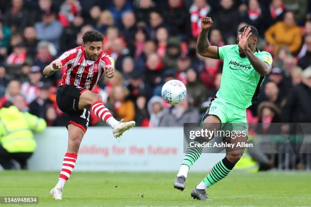 Bruno Andrade of Lincoln City has a shot on goal as Ryan Jackson of Colchester United attempts to block the shot during the Sky Bet League Two match...