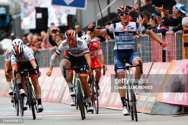 Team Nippo Vini Fantini Faizane' Italian rider Damiano Cima celebrates as he finishes first in the 18th stage of the 2019 Giro d'Italia, the cycling...