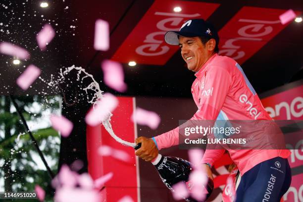 Team Movistar rider Ecuador's Richard Carapaz celebrates on the podium after winning the overall leader's pink jersey at the end of the stage...