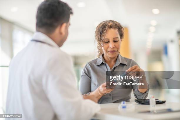 diabetic patient meets with her doctor - insulin pen stock pictures, royalty-free photos & images
