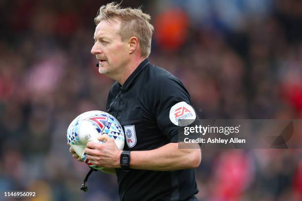 Referee Trevor Kettle holds a flat match ball during the Sky Bet League Two match between Lincoln City and Colchester United at Sincil Bank Stadium...