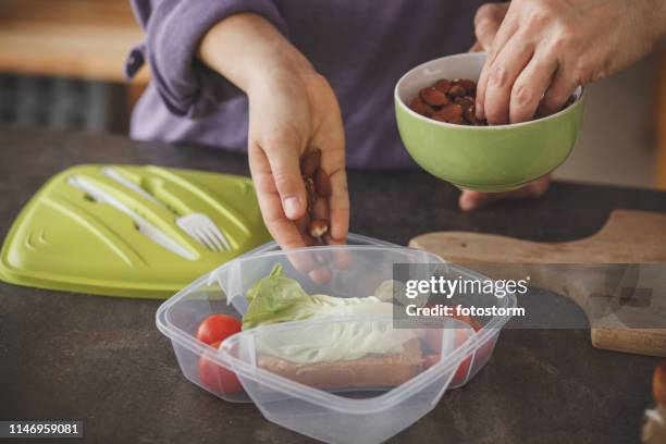 woman packing a healthy school lunch for her daughter - almond stock pictures, royalty-free photos & images