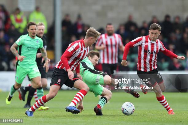 Tom Lapsile of Colchester United keeps possession of the ball during the Sky Bet League Two match between Lincoln City and Colchester United at...