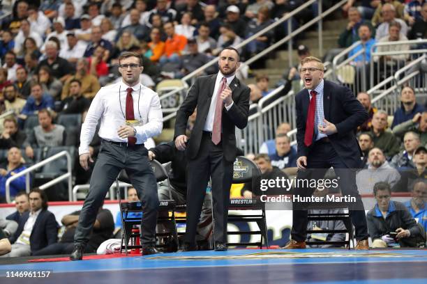 Assistant coaches Gabe Dean, Mike Grey and Kyle Dake of the Cornell Big Red coach during the championship finals of the NCAA Wrestling Championships...
