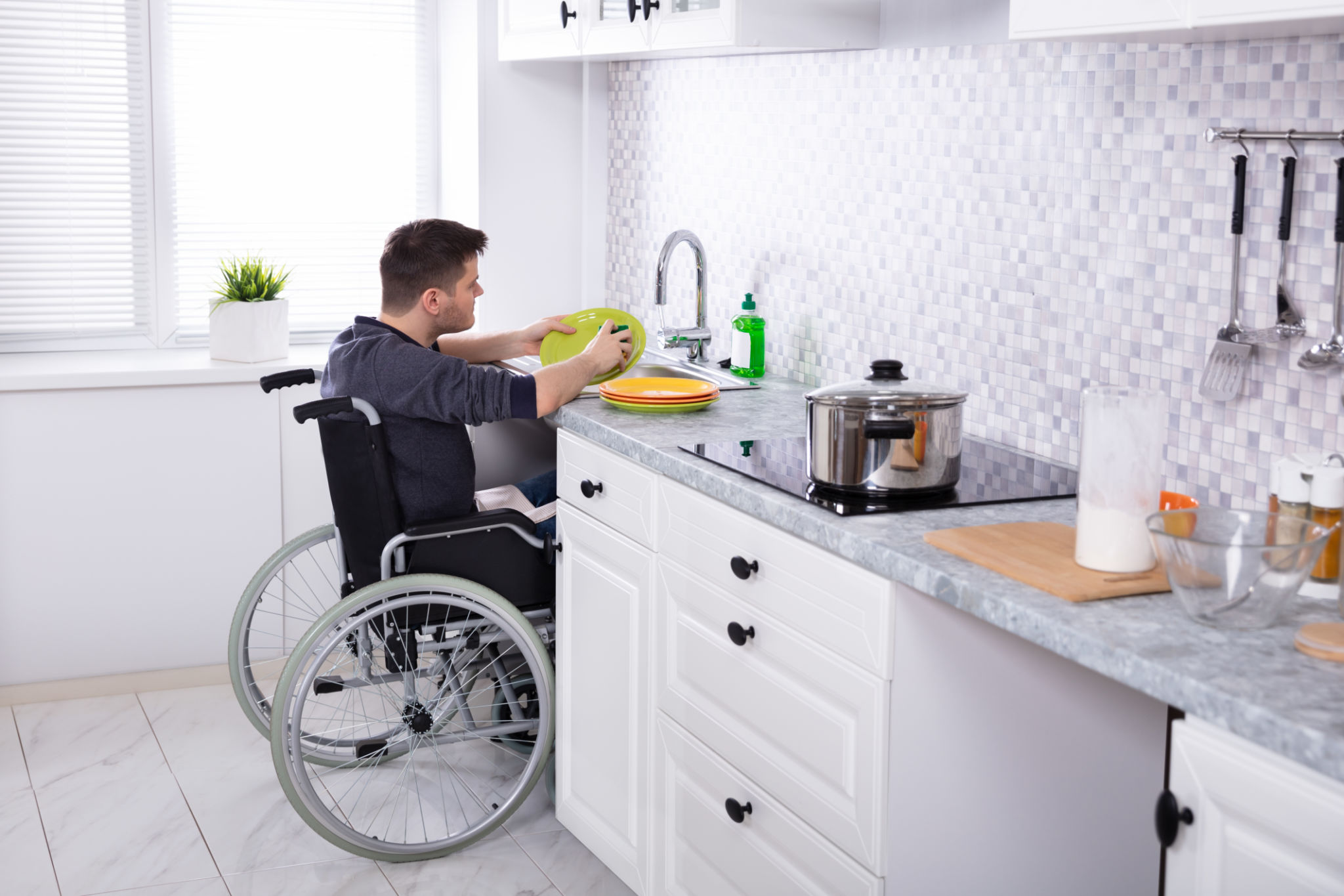 Handicapped Man Cleaning Dishes In Kitchen Handicapped Man Cleaning Dishes In Kitchen