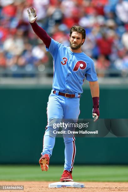 Bryce Harper of the Philadelphia Phillies waves after hitting a double in the fourth inning against the St. Louis Cardinals at Citizens Bank Park on...