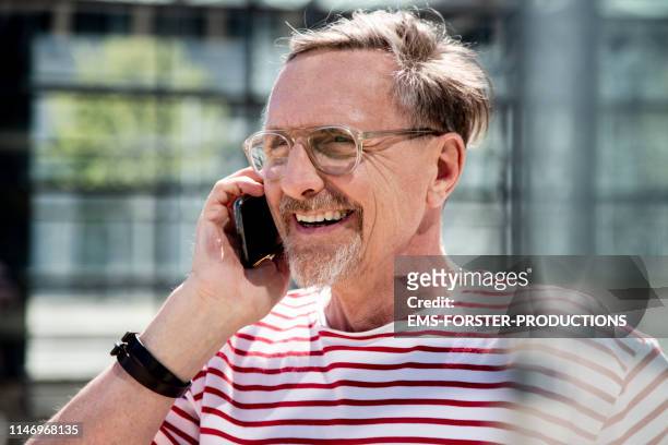 active Senior Man Talking an smiling  on cell phone