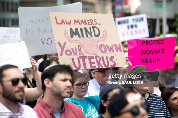 Thousands of demonstrators march in support of Planned Parenthood and pro-choice as they protest a state decision that would effectively halt...