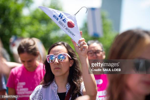 Thousands of demonstrators march in support of Planned Parenthood and pro-choice as they protest a state decision that would effectively halt...