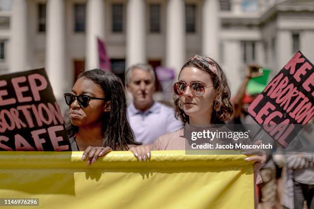 Kellyn Nettles and Colleen McGrath hold up a sign during a rally to protest the closure of the last abortion clinic in Missouri on May 30, 2019 in St...