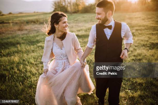 young playful wedding couple - wedding couple laughing stock pictures, royalty-free photos & images