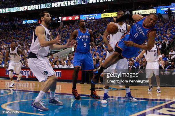 Russell Westbrook of the Oklahoma City Thunder attempts to save the ball in the first half against the Dallas Mavericks in Game Five of the Western...