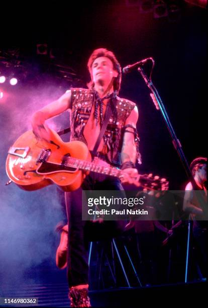 American Rock musician Rick Springfield plays guitar as he performs onstage at the Rosemont Horizon, Rosemont, Illinois, July 6, 1983.
