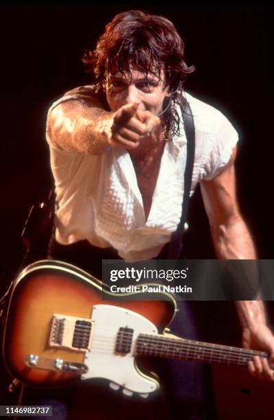 American Rock musician Rick Springfield plays guitar as he performs onstage at the Poplar Creek Music Theater, Hoffman Estates, Illinois, August 31,...