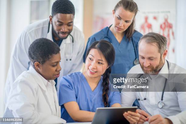 doctors working together - resident stock pictures, royalty-free photos & images