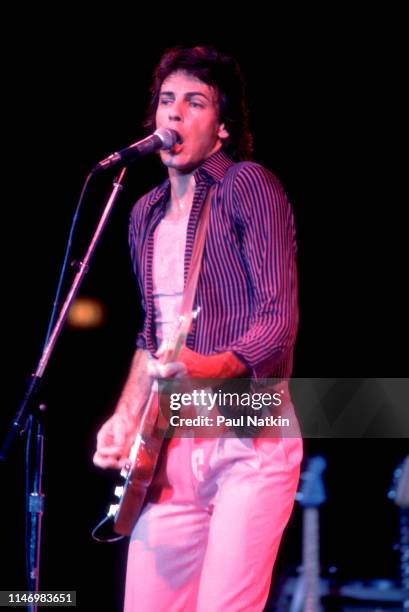 American Rock musician Rick Springfield plays guitar as he performs onstage at the Mill Run Theater, Niles, Illinois, September 6, 1981.