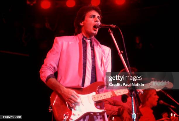 American Rock musician Rick Springfield plays guitar as he performs onstage at the Mill Run Theater, Niles, Illinois, September 6, 1981.