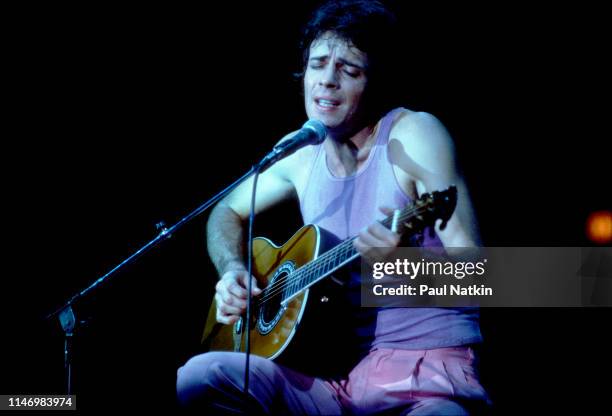 American Rock musician Rick Springfield plays guitar as he performs onstage at the Mill Run Theater, Niles, Illinois, September 6, 1981.