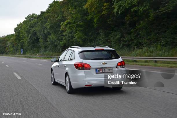 chevrolet driving on the highway - estate car stock pictures, royalty-free photos & images