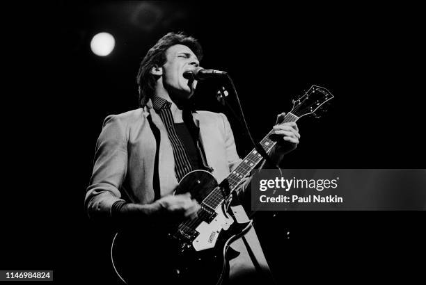 American Rock musician Rick Springfield plays guitar as he performs onstage at the Holiday Star Theater, Merilville, Indiana, November 18, 1981.