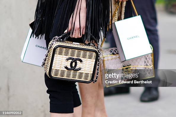 A guest wears a Chanel vanity bag, outside the Chanel Cruise