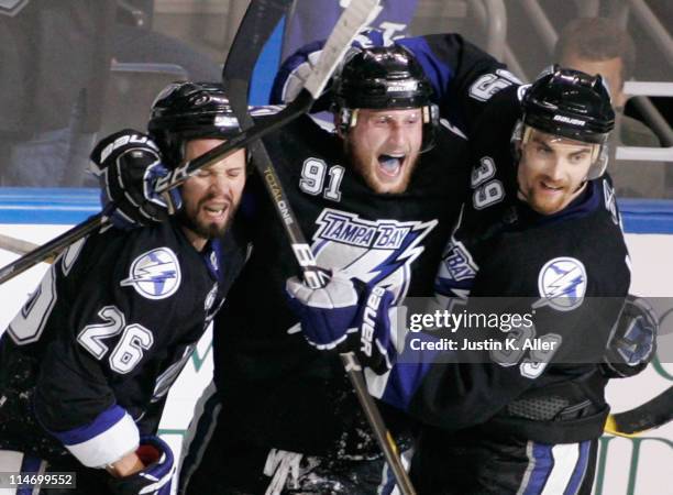 Martin St. Louis celebrates his third period goal with Steven Stamkos and Mike Lundin of the Tampa Bay Lightning in Game Six of the Eastern...